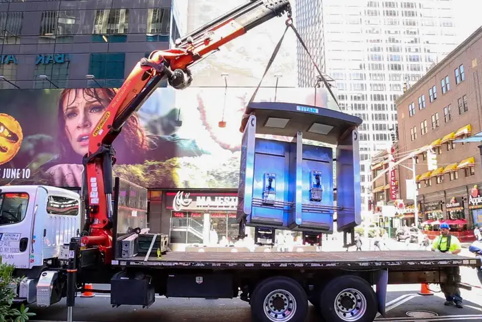 A photo of a payphone being removed from Times Square